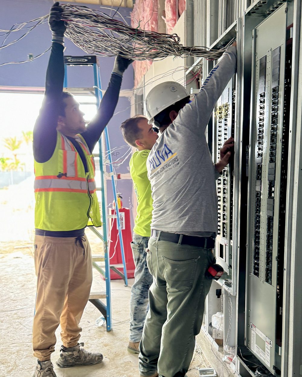 A Nova Electrical Contractors electrician installing an electrical panel