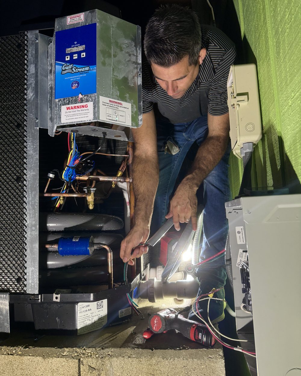 A Nova Electrical Contractors electrician working inside an electrical panel