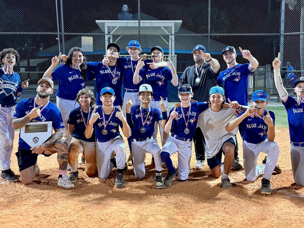 A Nova-sponsored youth baseball team celebrating on the field after a win